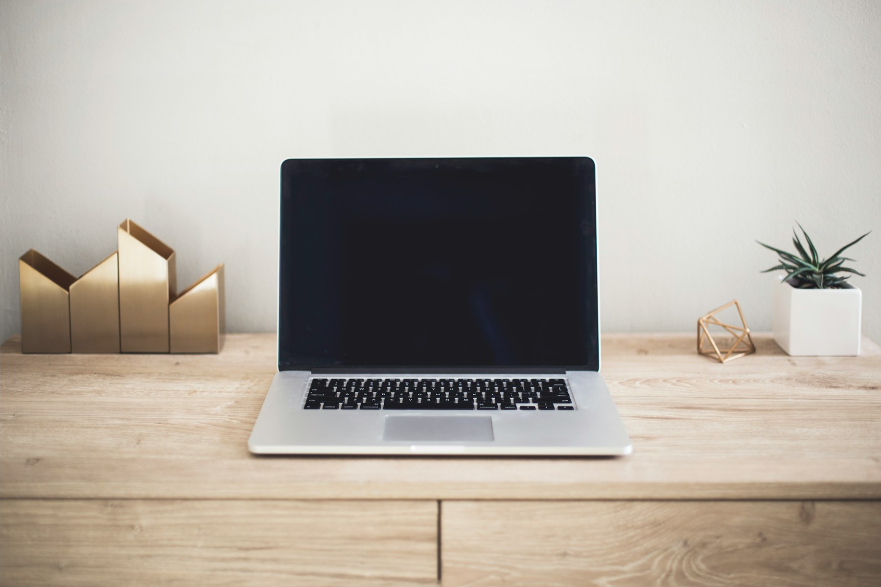 Laptop photograph inside an illustrative website frame